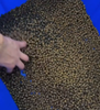 Why should the protein content of feed be reduced during periods of high temperature?